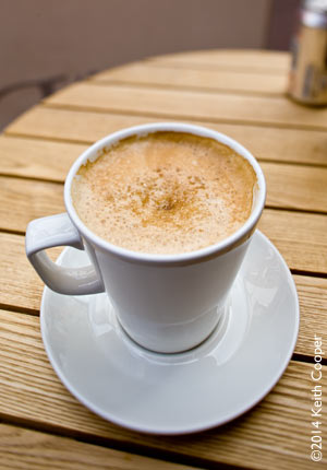 cup of coffee on wooden table top